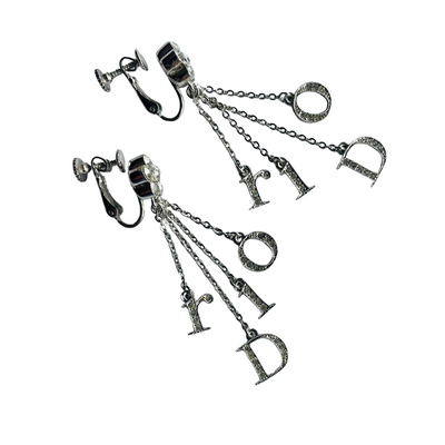 Close-up of vintage Dior Galliano era logo letter charms spelling Dior, crystal-set, suspended on delicate rhodium-plated chains, showing Dior stamp on reverse of D charm