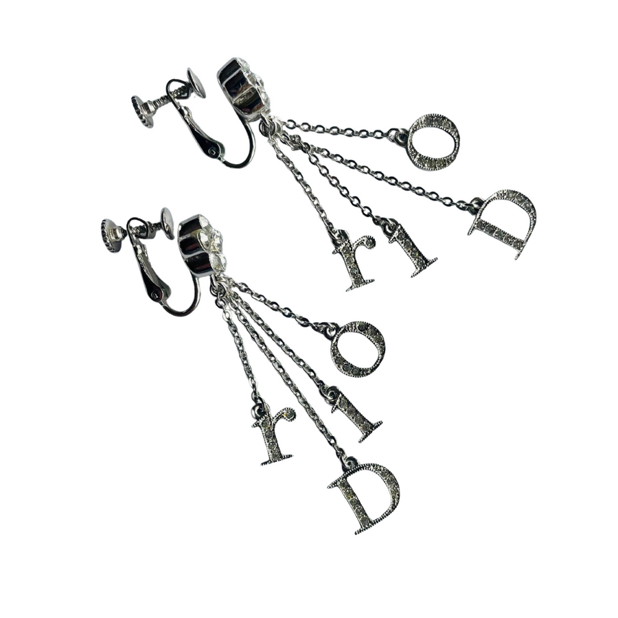 Close-up of vintage Dior Galliano era logo letter charms spelling Dior, crystal-set, suspended on delicate rhodium-plated chains, showing Dior stamp on reverse of D charm