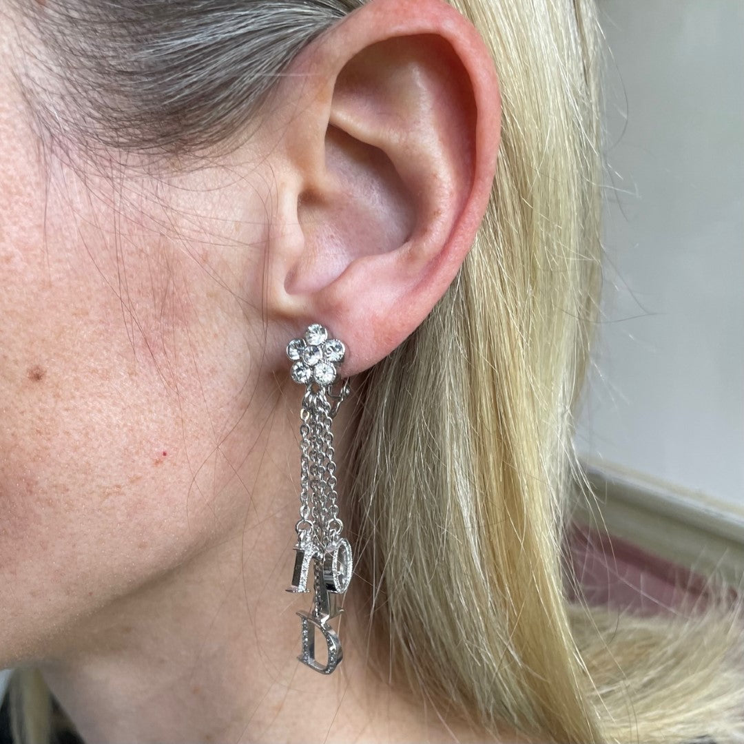 model shot of vintage Dior Galliano era logo letter charms spelling Dior, crystal-set, suspended on delicate rhodium-plated chains, showing Dior stamp on reverse of D charm