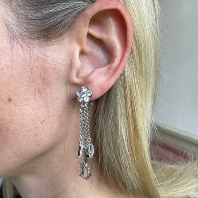 model shot of vintage Dior Galliano era logo letter charms spelling Dior, crystal-set, suspended on delicate rhodium-plated chains, showing Dior stamp on reverse of D charm
