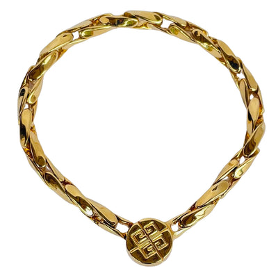 Gold-tone vintage Givenchy chain bracelet from the 1980s, featuring polished interlocking links and a round magnetic clasp engraved with the iconic 4G logo.