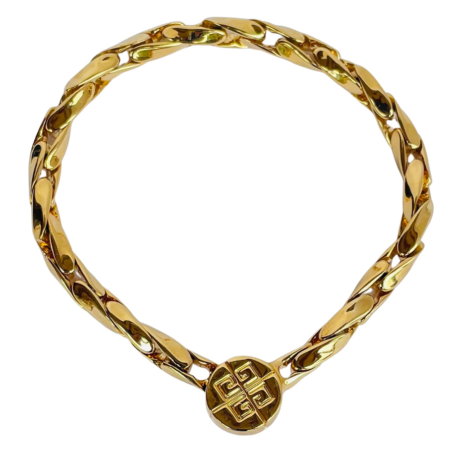 Gold-tone vintage Givenchy chain bracelet from the 1980s, featuring polished interlocking links and a round magnetic clasp engraved with the iconic 4G logo.