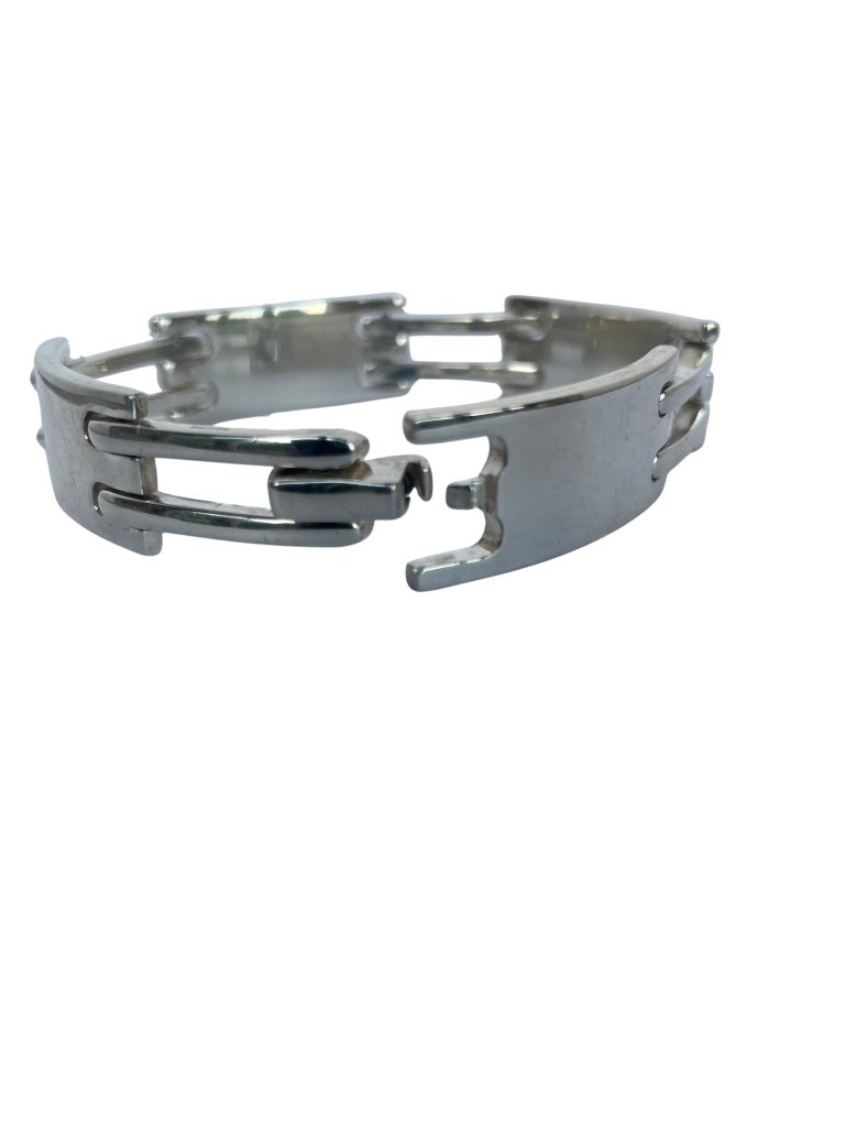 Vintage Gucci men's sterling silver gate-link ID plate bracelet with signature Gucci engraved central plate, white background. Showing clasp