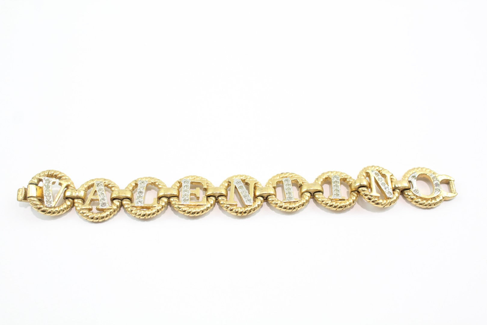 Gold tone Valentino chain link bracelet spelling Valentino