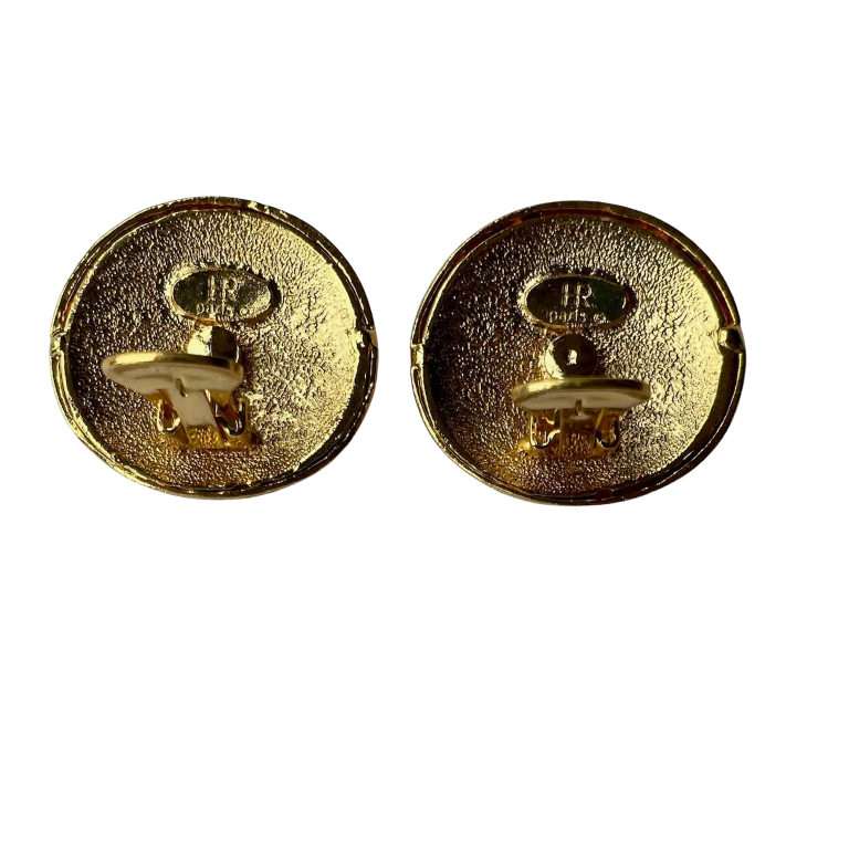 reverse side side of a pair of vintage 1980s Helena Rubinstein Paris domed clip-on earrings. Each button-style earring features a smooth, cream-colored faux pearl base overlaid with intricate gold-tone fluting and two interlocking circular motifs encrusted with small, glittering clear rhinestones, showing the HR Paris backstamp