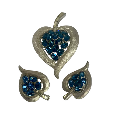 Vintage Crown Trifari cornflower blue oval crystal clip earrings in brushed silver Trifanium, signed, with clear baguette stones. Alfred Philippe era, 1960s. Shown with matching brooch