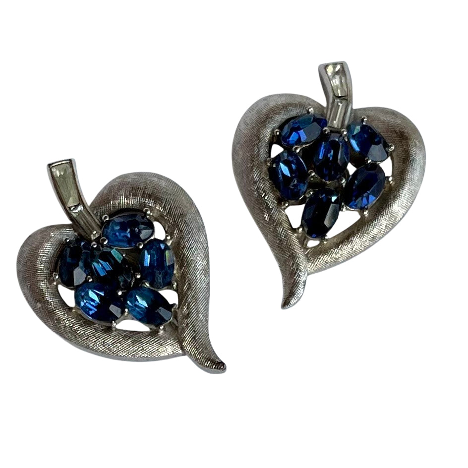 Vintage Crown Trifari cornflower blue oval crystal clip earrings in brushed silver Trifanium, signed, with clear baguette stones. Alfred Philippe era, 1960s.