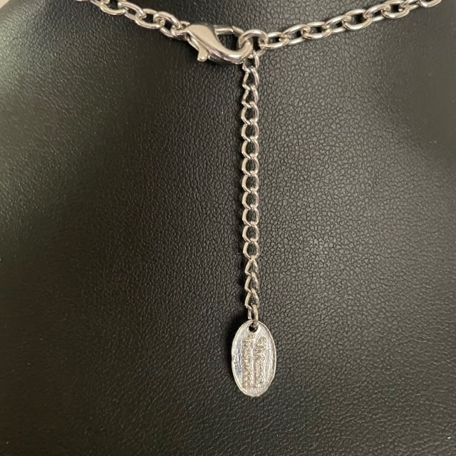 reverse of  Vivienne Westwood vintage necklace showing silver chain and tag on a white background