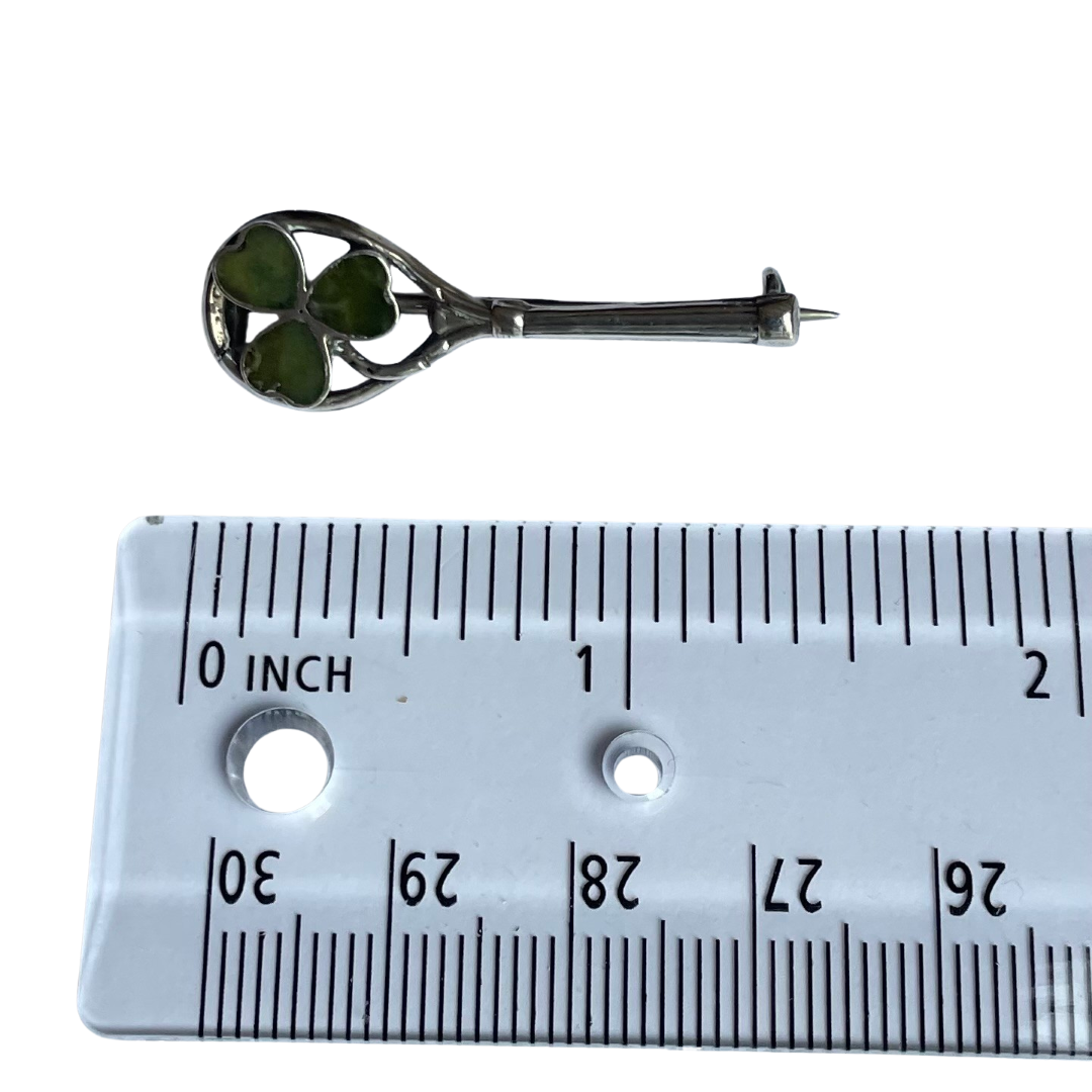 Antique 1916 sterling silver tennis racket brooch with Connemara green marble shamrock. Shown with ruler for scale.