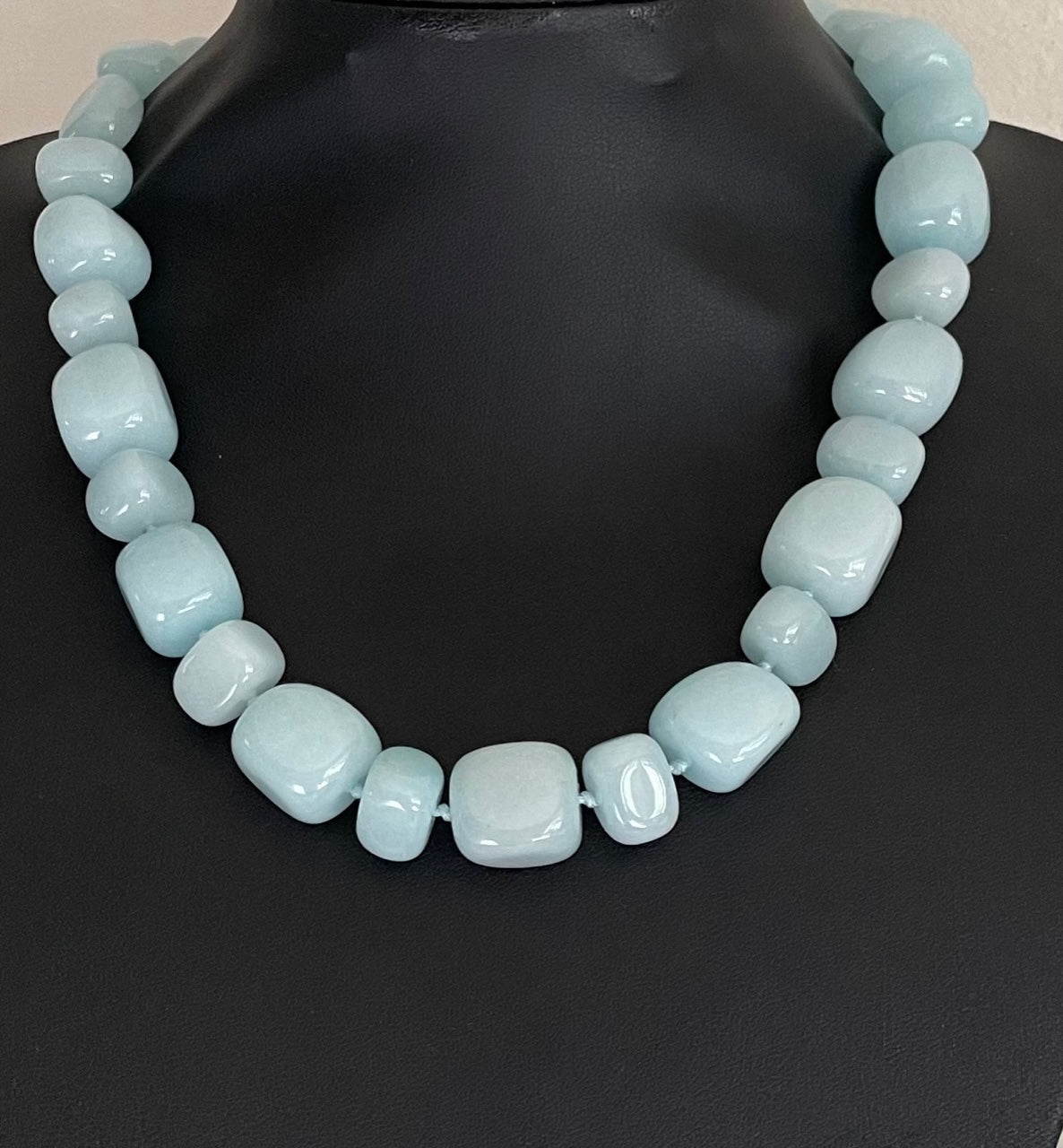 Lola Rose milky-aqua blue quartzite statement necklace with hand-knotted pillow nugget beads and a round yellow-gold-tone charm on an adjustable cord