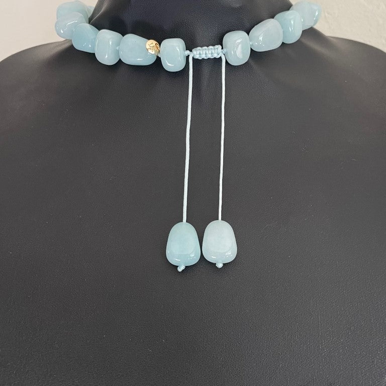 reverse of Lola Rose milky-aqua blue quartzite statement necklace with hand-knotted pillow nugget beads and a round yellow-gold-tone charm on an adjustable cord
