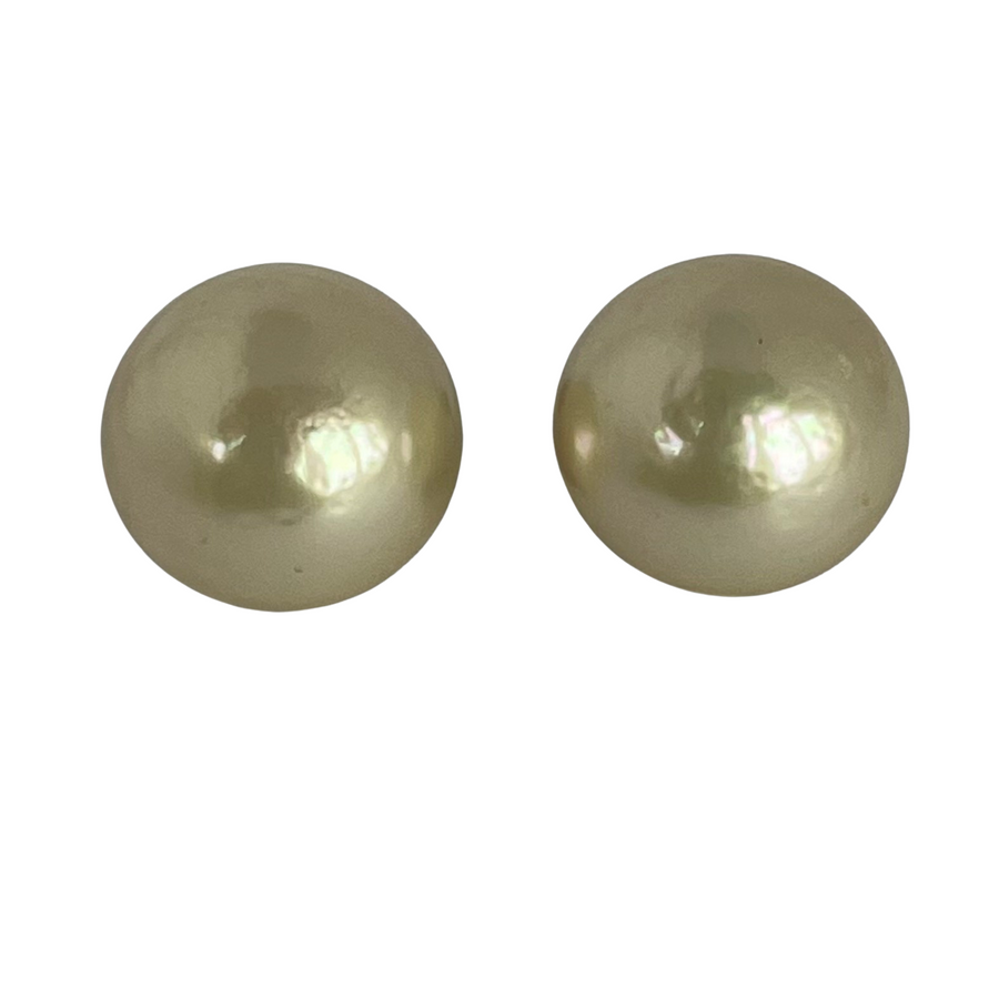 Pair of vintage Christian Dior button pearl earrings on a white background