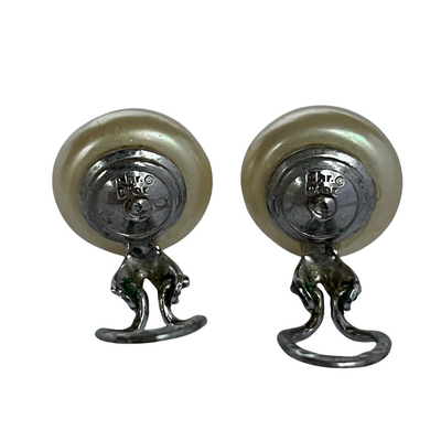 reverse showing Christian Dior signature on pair button pearl earrings on a white background