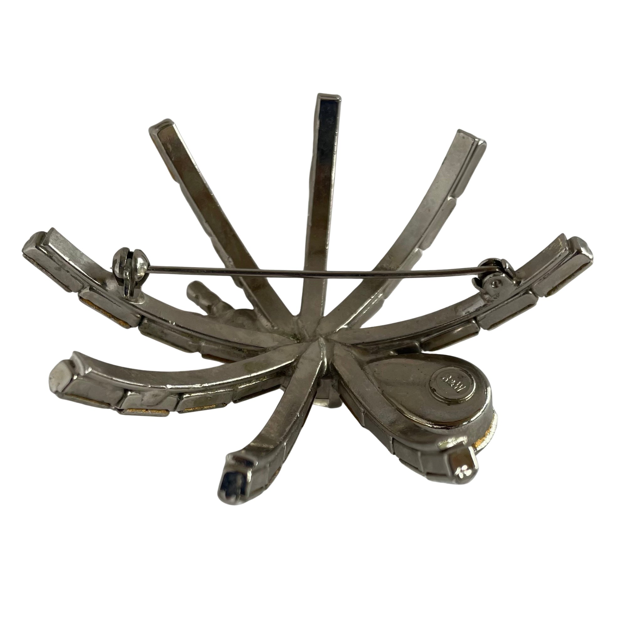a very large 1980s Butler & Wilson spider brooch with clear faceted crystals on a silver-tone metal base  showing the early Butler & Wilson B & W backstamp, displayed  on a white background.