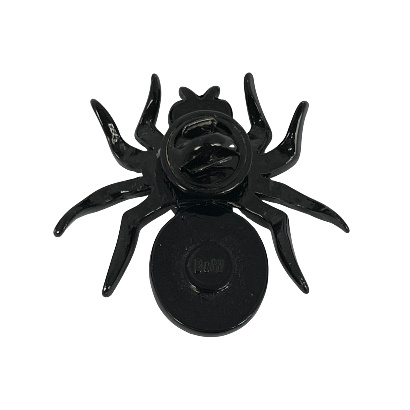 reverse side of early vintage Butler & Wilson black-coated metal mini spider pin with ruby red cabochon body, amber thorax crystal, and shimmering AB crystal legs. Showing B&W backstamp and butterfly closure.
