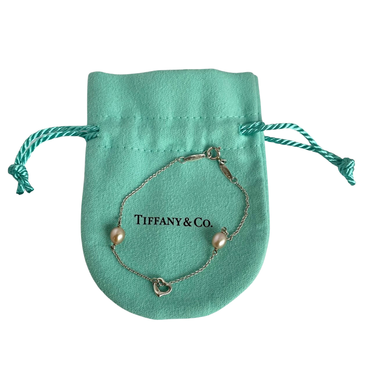 Tiffany & Co. Elsa Peretti Silver bracelet with pink pearls on a white background shown on original Tiffany pouch