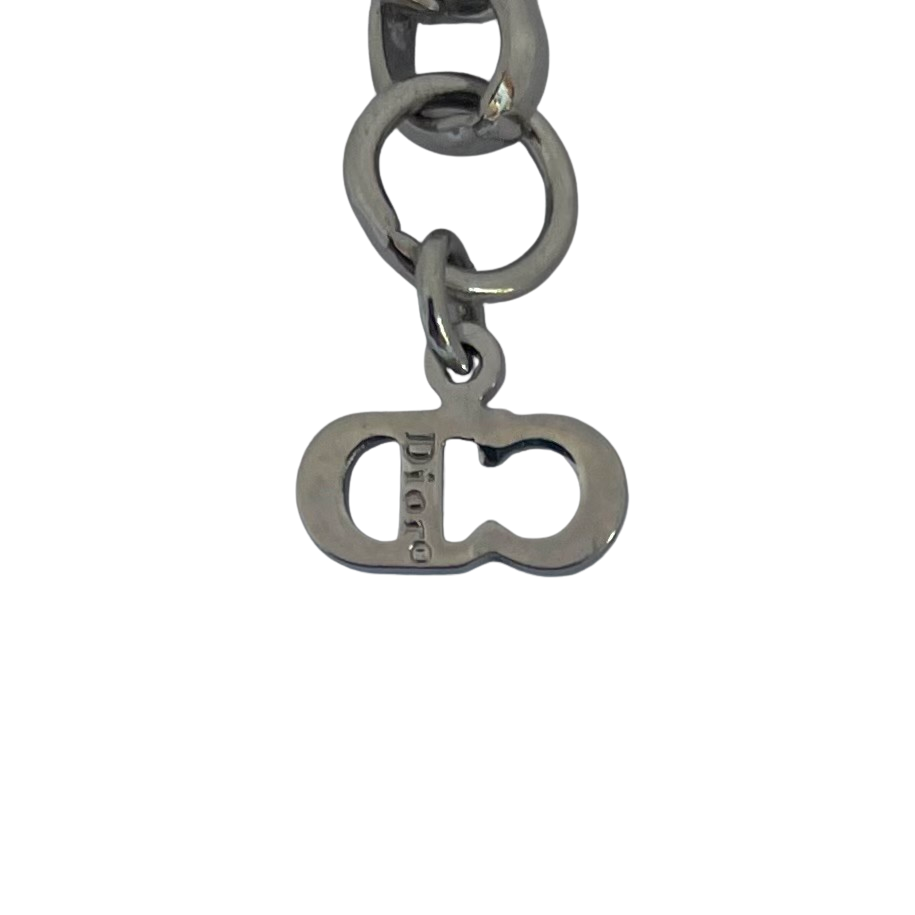 Christian Dior silver-tone bracelet with knotted bow detail and CD initial charms, John Galliano era Y2K. close up of Dior signature.