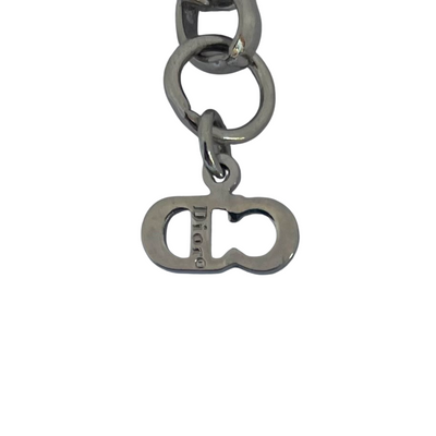 Christian Dior silver-tone bracelet with knotted bow detail and CD initial charms, John Galliano era Y2K. close up of Dior signature.