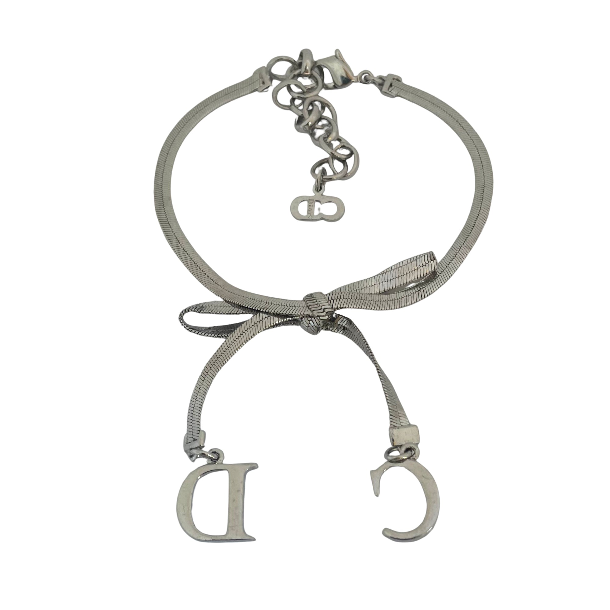 reverse of Christian Dior silver-tone bracelet with knotted bow detail and CD initial charms, John Galliano era Y2K