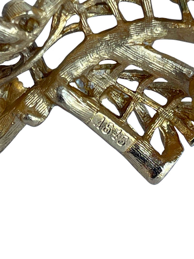 Close-up of the reverse of a Sphinx A645 vintage brooch, showing the authentic design number stamp, openwork filigree, and secure rollover clasp