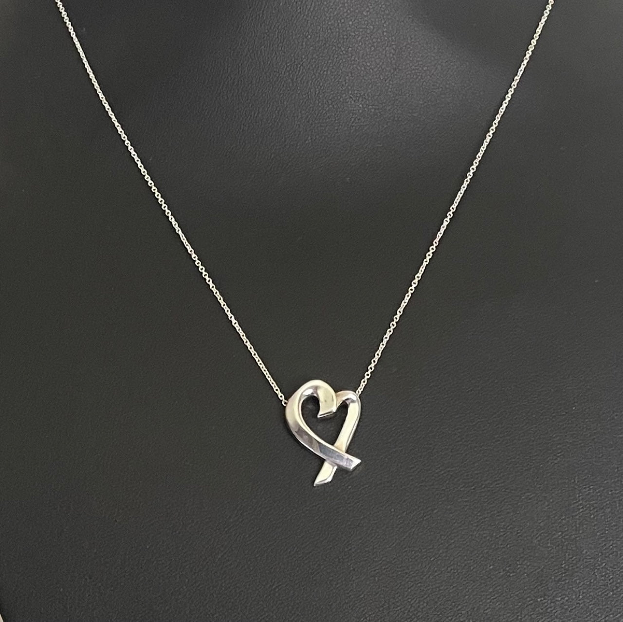 Paloma Picasso for Tiffany & Co Loving Heart silver pendant necklace displayed on jewellery bust