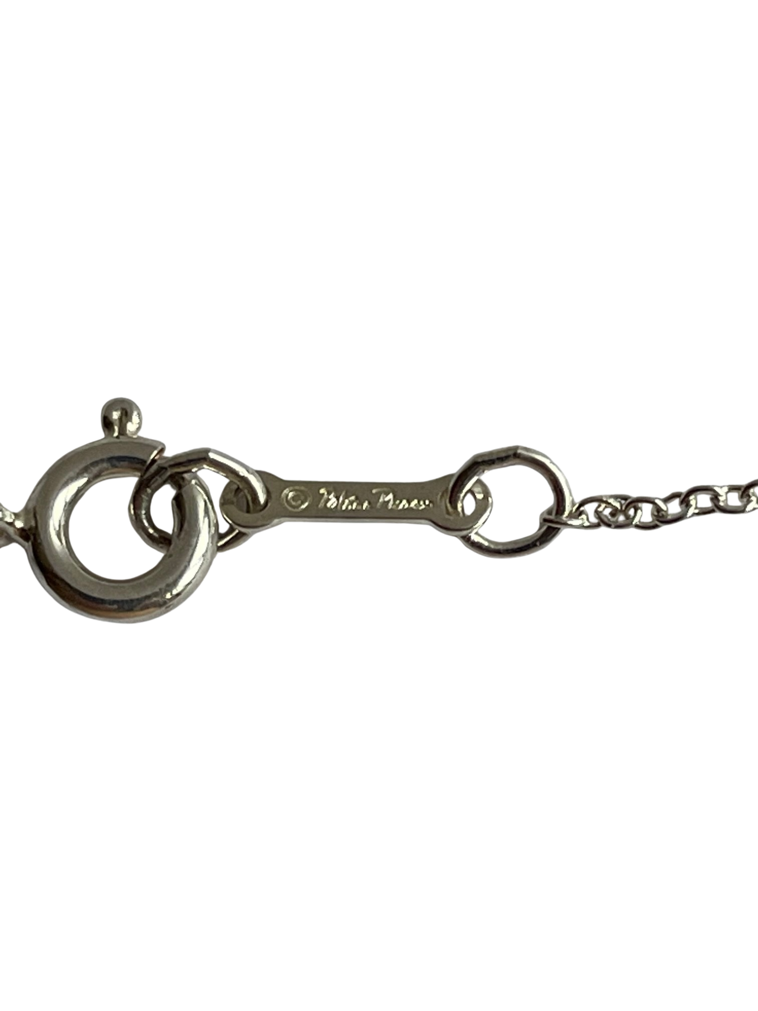 Close-up of necklace clasp bar engraved with Paloma Picasso signature