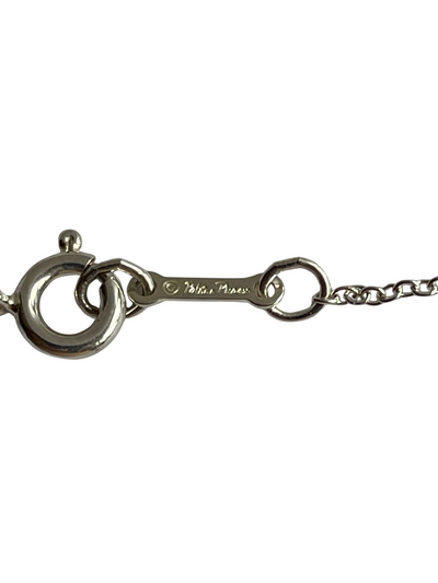 Close-up of necklace clasp bar engraved with Paloma Picasso signature