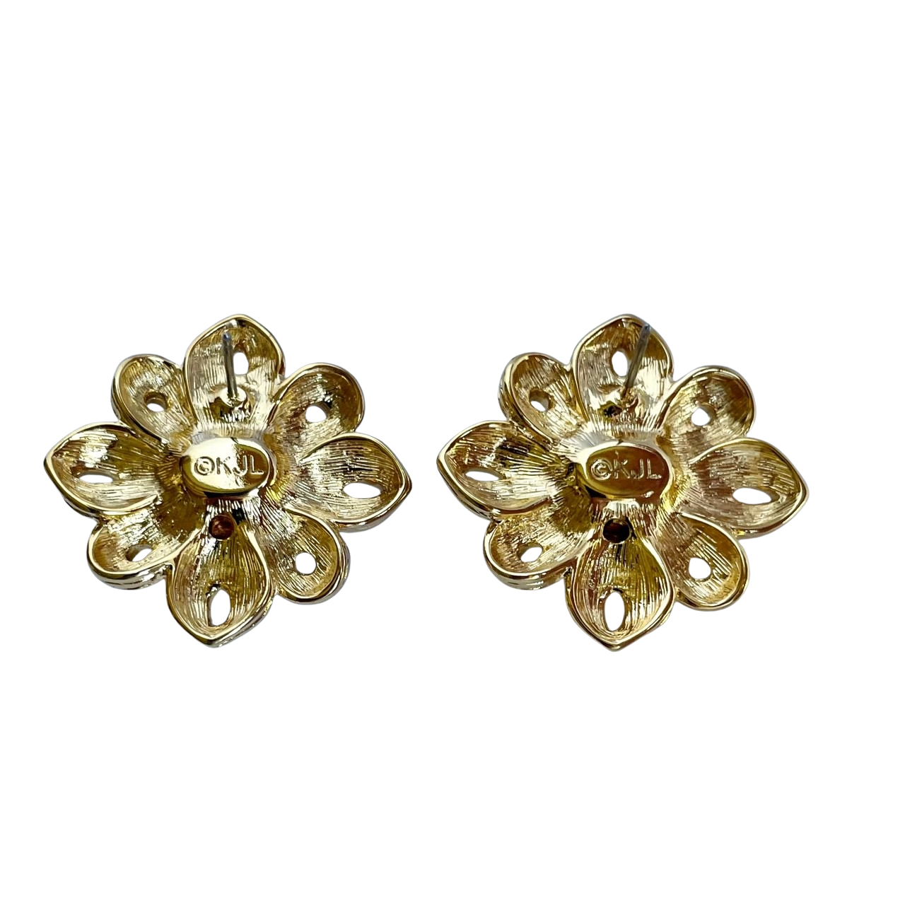 Reverse side of a vintage gold-tone sunburst earring showing a stippled texture, post backing, and a raised oval cartouche stamped with the official ©KJL hallmark.