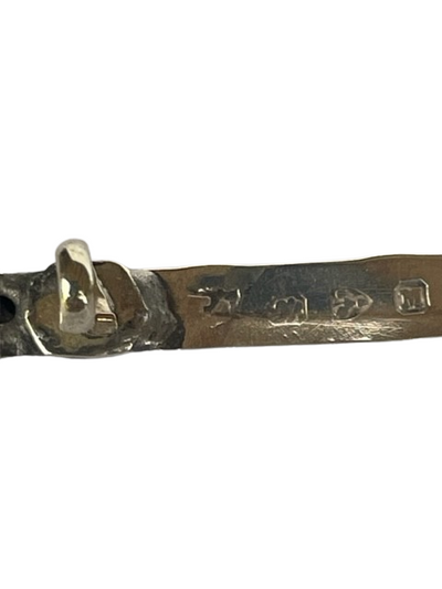 showing the hallmarks on a vintage sterling silver tennis racquet brooch with Birmingham 1936 hallmarks