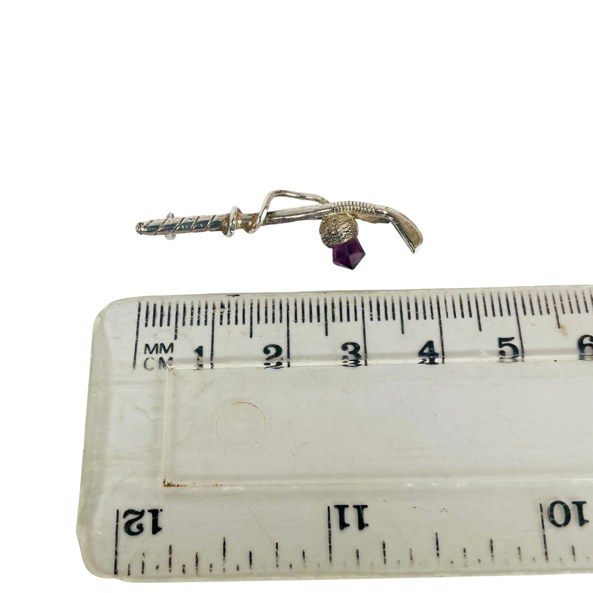 Sterling silver brooch in the form of a golf club with amethyst crystal thistle showing length 4 cm