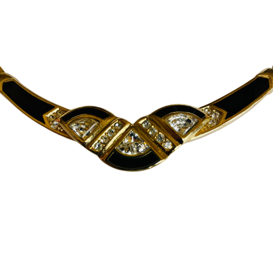 Gold necklace with black accents and gemstones on a white background on a whitebackround