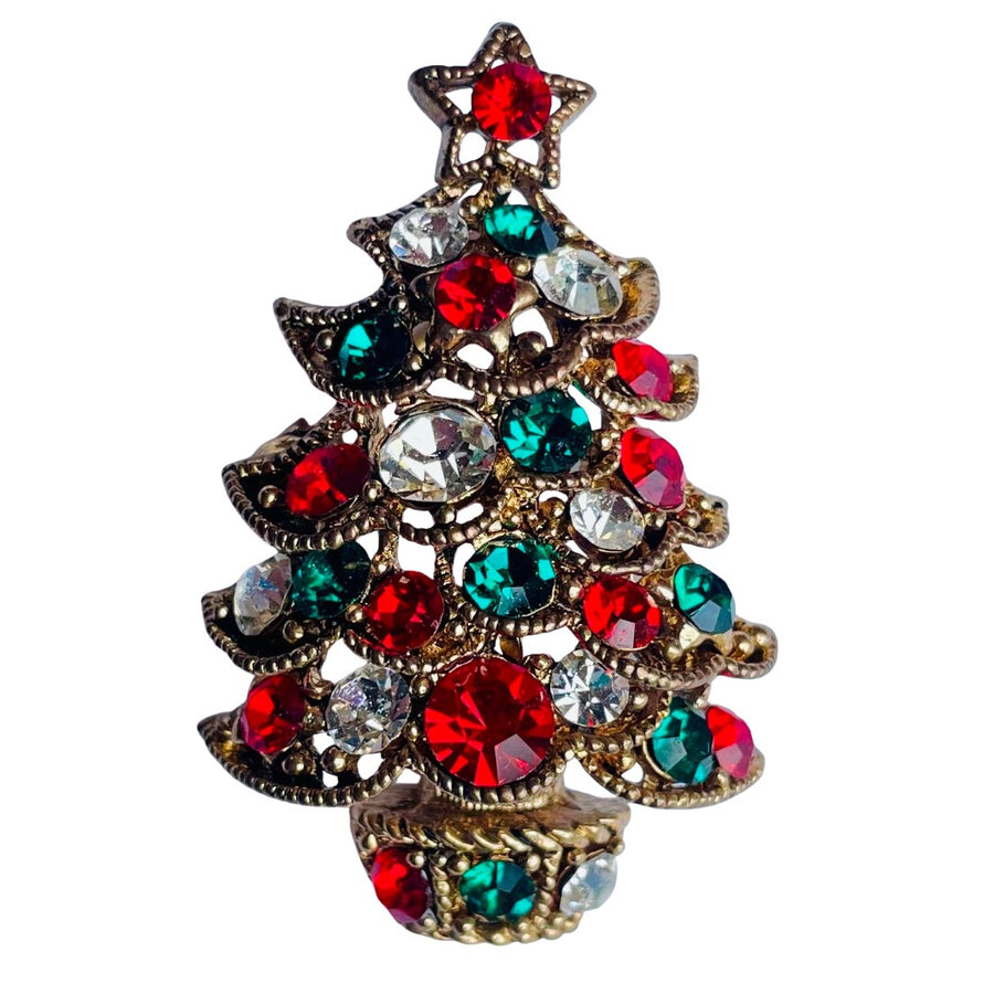 Butler & Wilson Christmas tree brooch with red, green, and clear gemstones on a white background