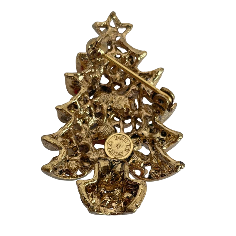 reverse side of Butler & Wilson Christmas tree brooch showing Butler & Wilson cartouche on a white background