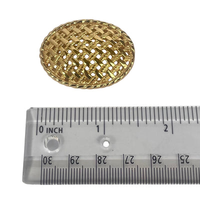 Dior gold plated basket weave brooch on white background with ruler showing size