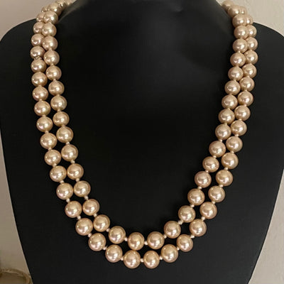 Vintage Vogue Bijoux double-strand faux pearl necklace with 10mm cream pearls, crystal rondelle spacers and an aquamarine crystal pavé-set clasp, 1980s.