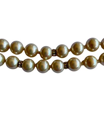 Vintage Vogue Bijoux double-strand faux pearl necklace with 10mm cream pearls, crystal rondelle spacers and an aquamarine crystal pavé-set clasp, 1980s.