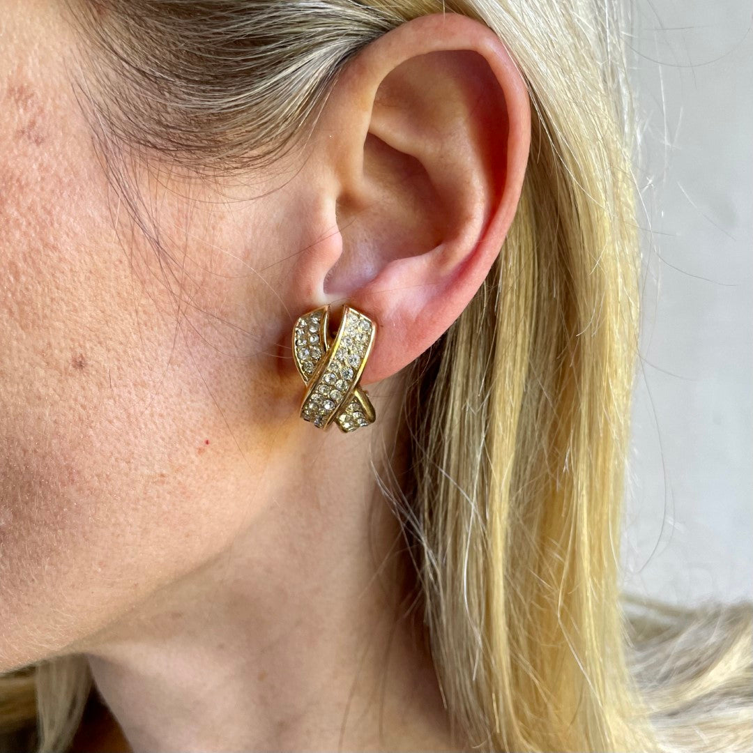 Vintage Christian Dior gold tone crystal kiss clip earrings on a model, 1980s signed Chr. Dior costume jewellery