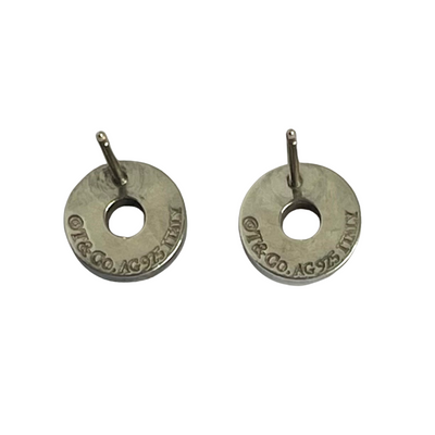 Reverse of pair of Tiffany & Co silver earrings with  T & Co AG 925 Italy engraving on a white background
