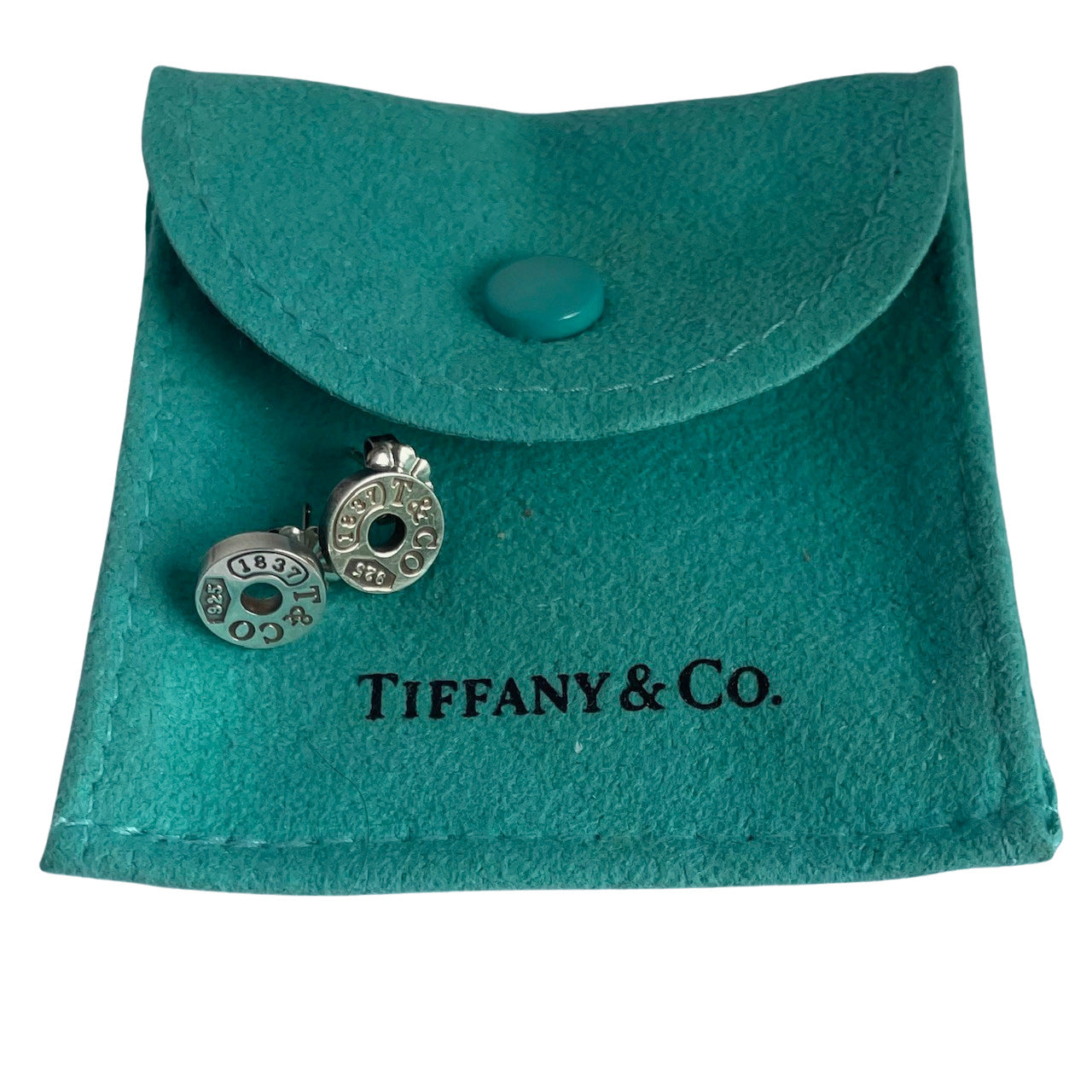Tiffany & Co. Silver Circle 1837 earrings on  Tiffany & Co. blue pouch