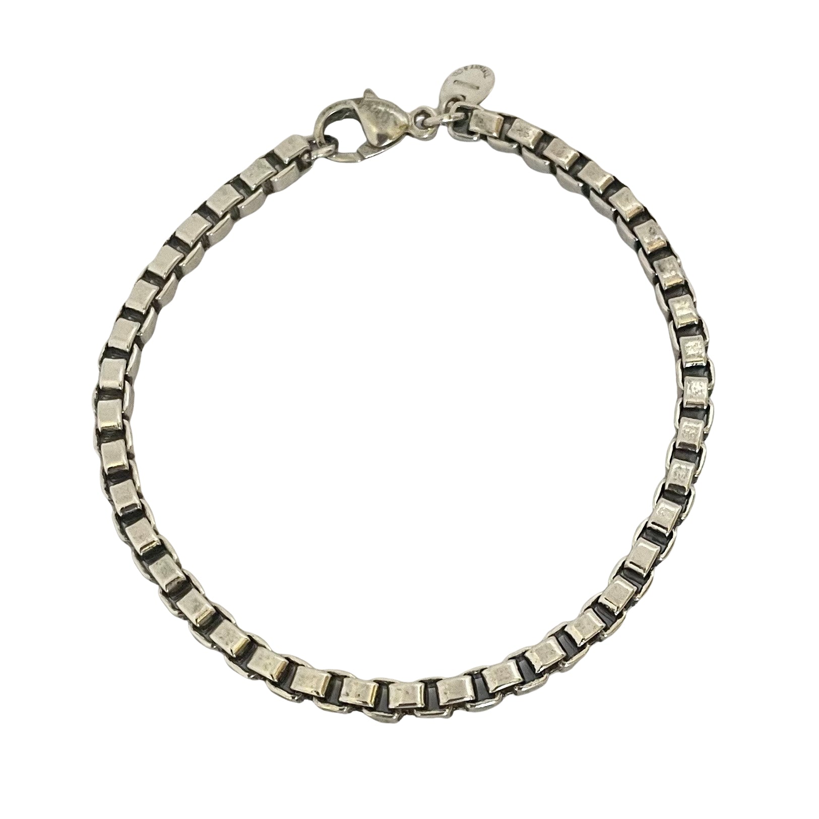 A vintage sterling silver Tiffany & Co. Venetian Link bracelet with square box links and a lobster clasp, on a white background