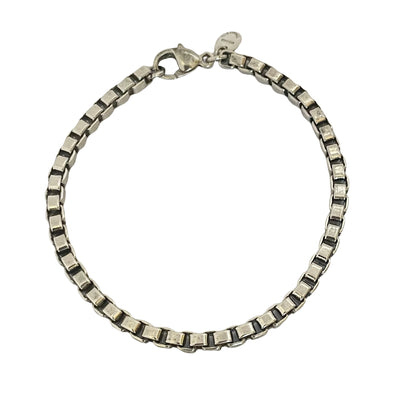 A vintage sterling silver Tiffany & Co. Venetian Link bracelet with square box links and a lobster clasp, on a white background