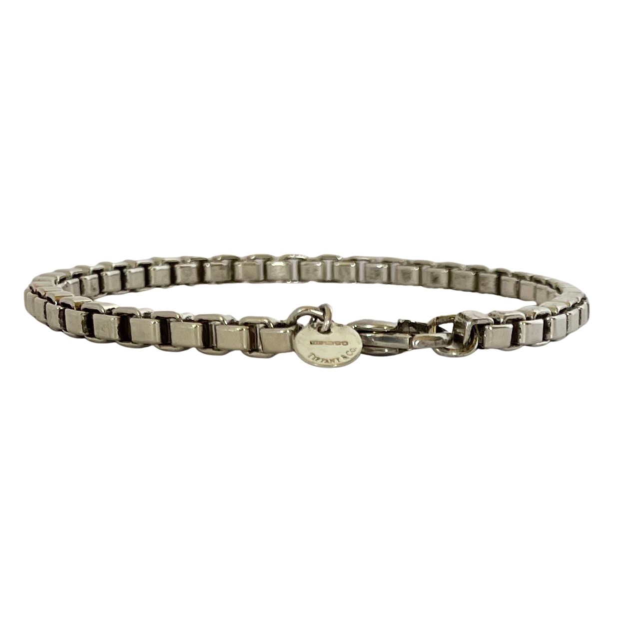 A vintage sterling silver Tiffany & Co. Venetian Link bracelet with square box links and a lobster clasp, on a white background