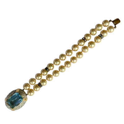 Full-length view of a 1980s Vogue Bijoux double-strand pearl bracelet. Displays 10mm cream pearls with crystal rondelles and a large aquamarine clasp.