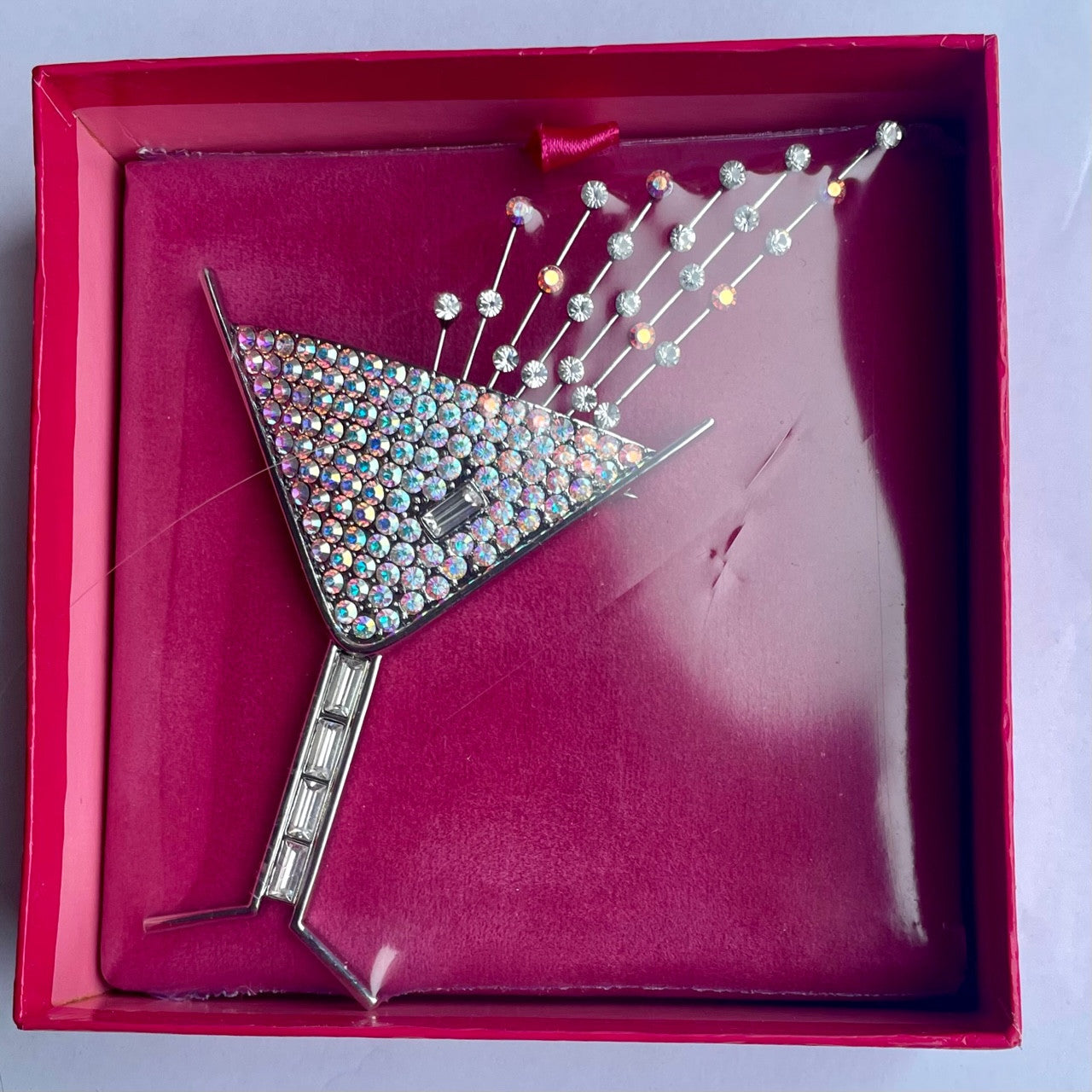 Butler & Wilson martini glass brooch set aurora borealis crystals with baguette cut crystals forming the stem and a baguette-cut crystal on the glass, shown sealed in its Butler & Wilson pink box