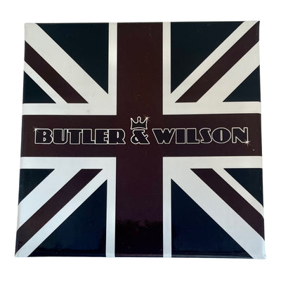 Butler and Wilson Art Deco brooch of a flapper lady in red enamel walking a gold glitter hound dog in a Union Jack box.