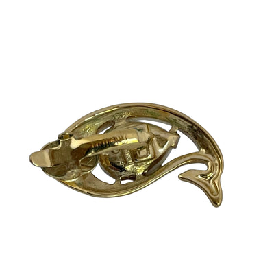 reverse side of vintage 1980s Trifari TM gold-tone fish clip-on earrings featuring a teardrop white lucite jelly belly cabochon.