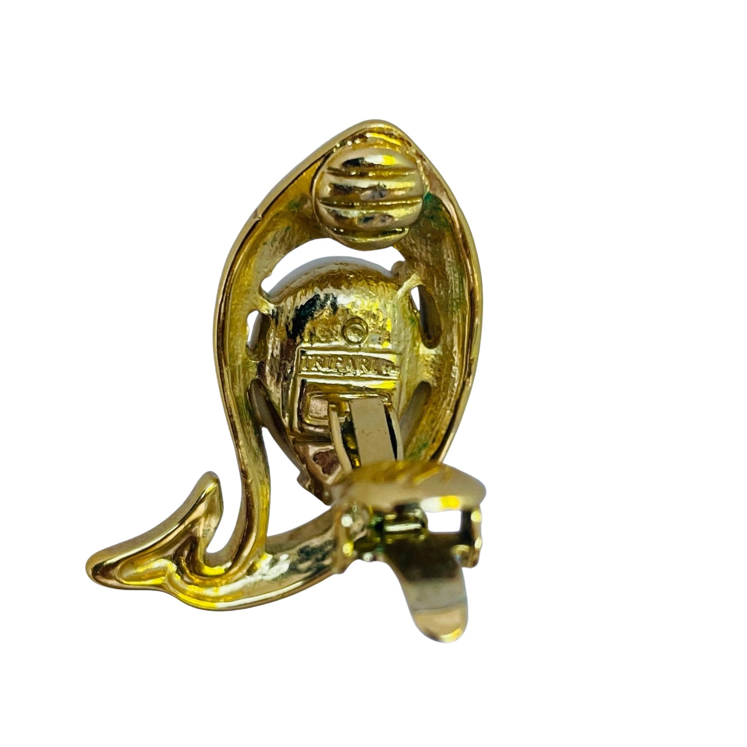 reverse side of vintage 1980s Trifari TM gold-tone fish clip-on earrings featuring a teardrop white lucite jelly belly