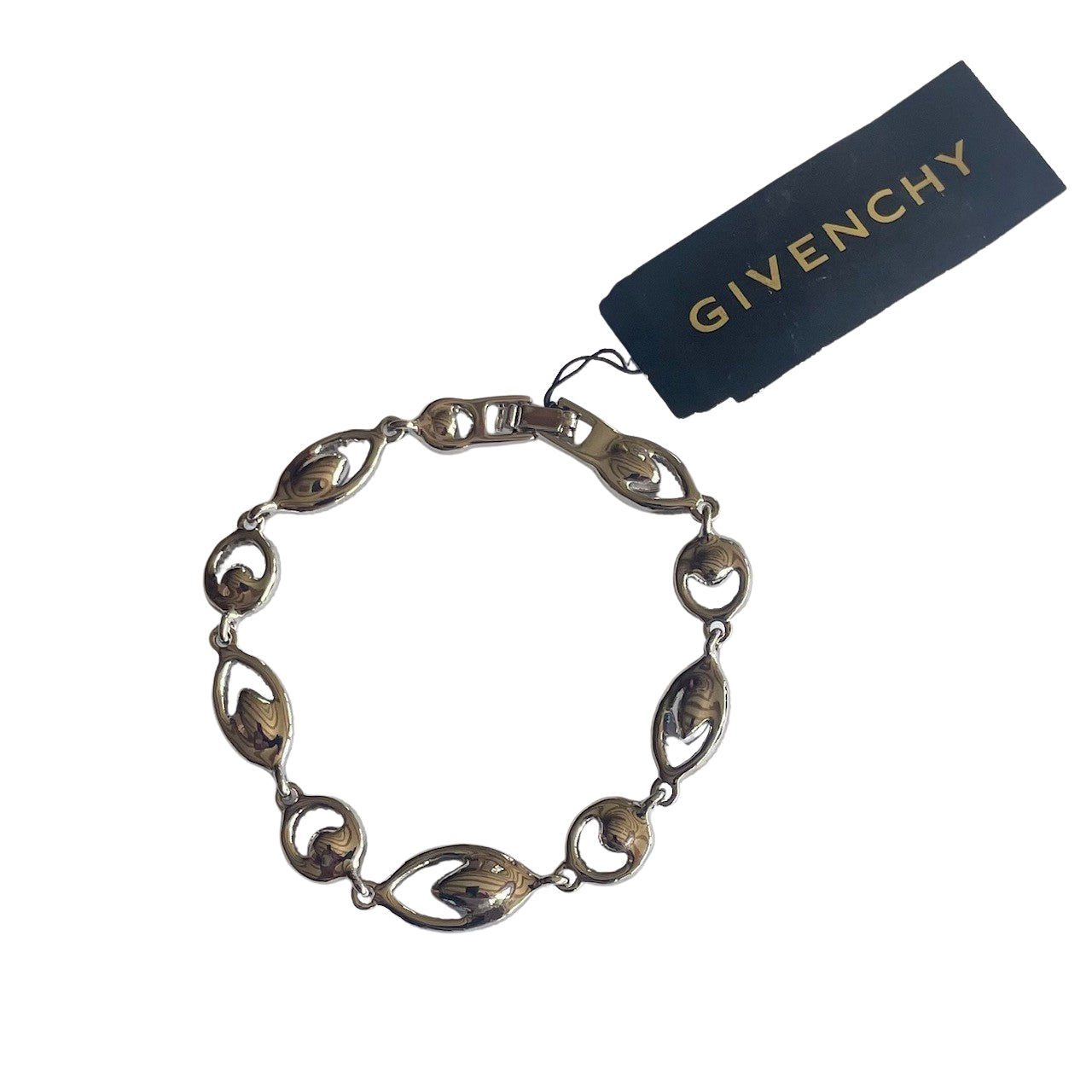 reverse of silver tone bracelet with blue and clear crystal stones and Givenchy logo on a white background