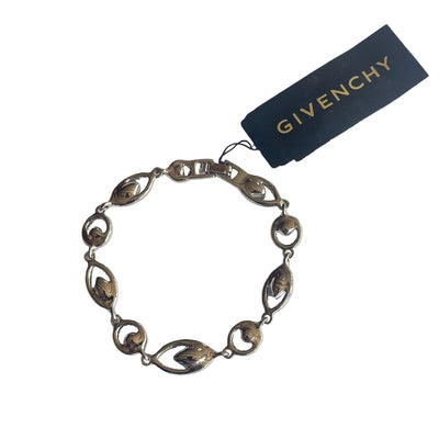 reverse of silver tone bracelet with blue and clear crystal stones and Givenchy logo on a white background