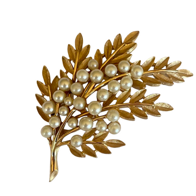 Vintage Crown Trifari 1960s leaf brooch with textured Trifanium leaves, lustrous faux pearls, and polished gold-tone stems, signed to the reverse.